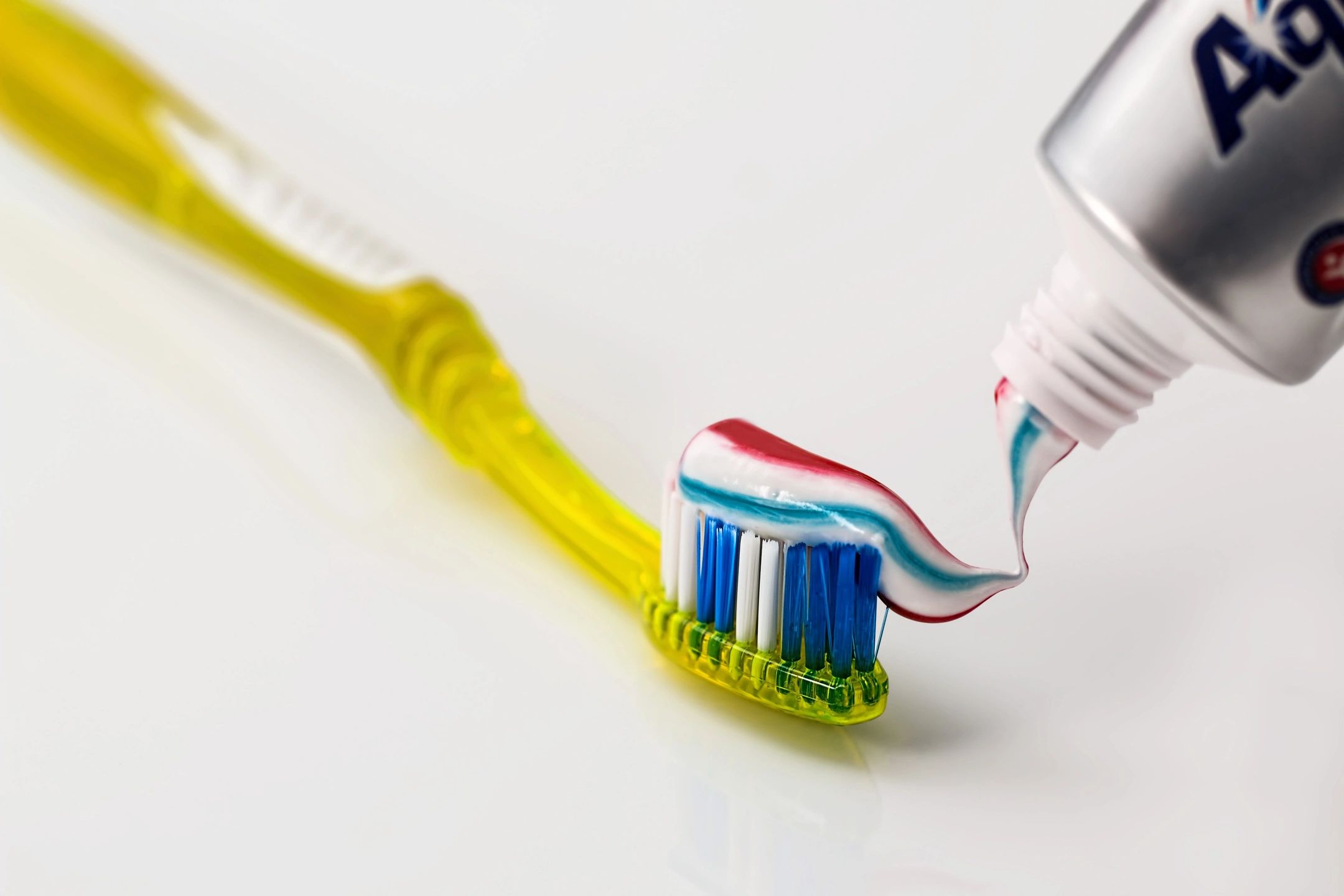 Yellow tooth brush with toothpaste